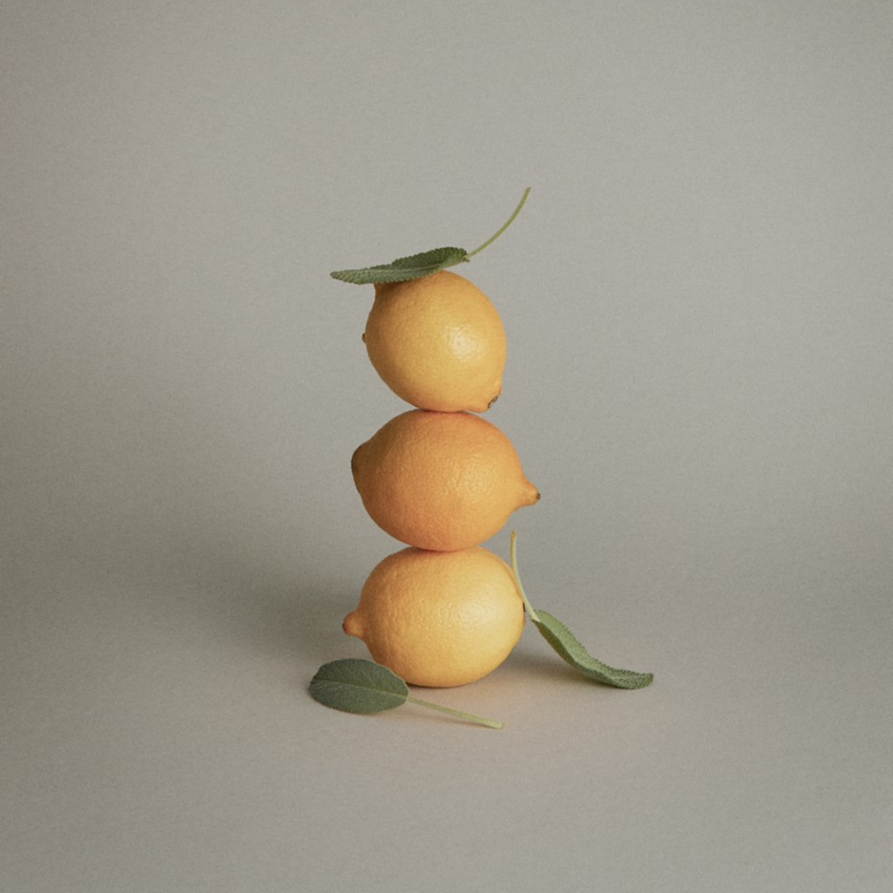 Lemons stacked on top of each other with sage 